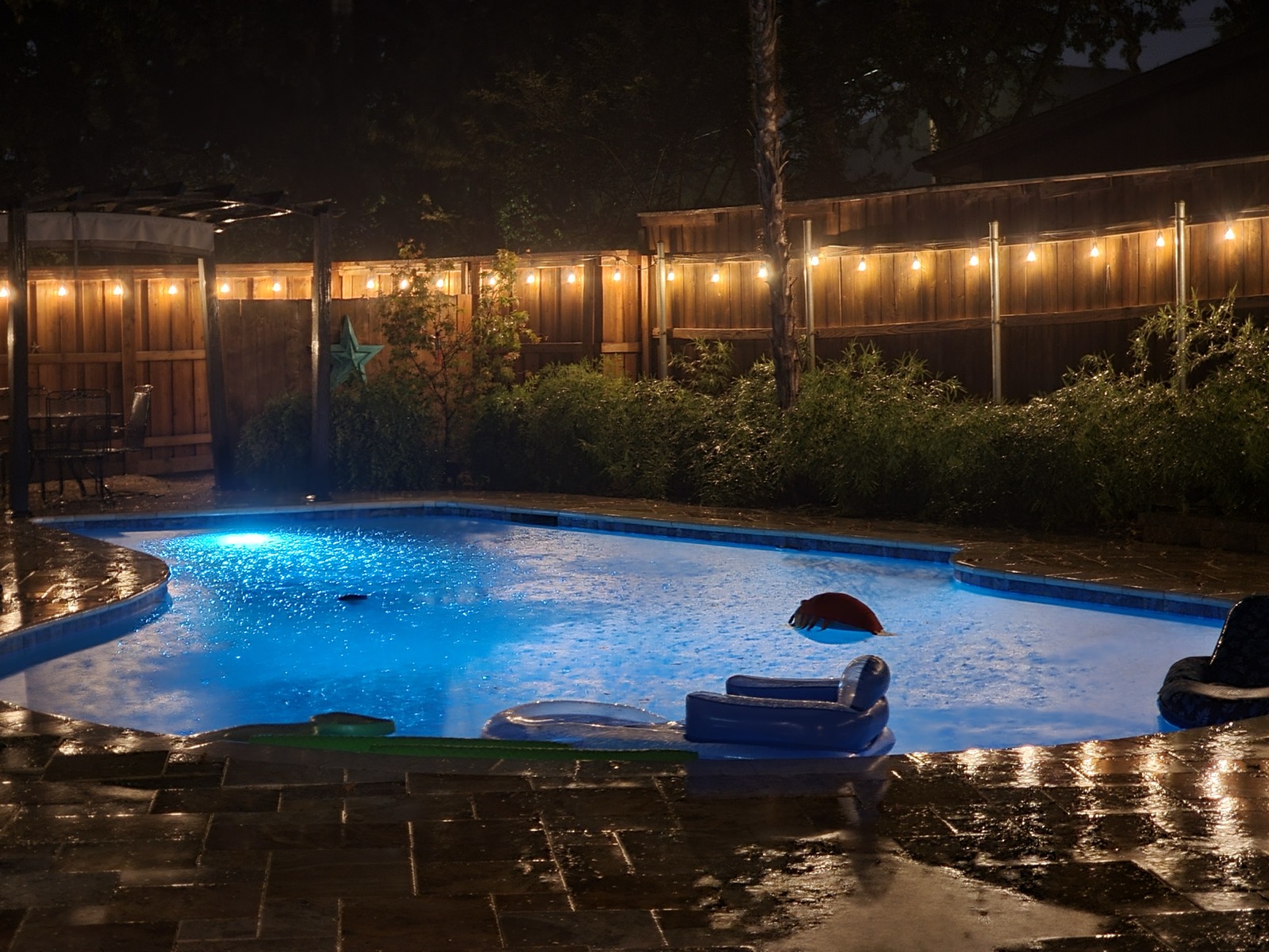 Backyard pool with string lights